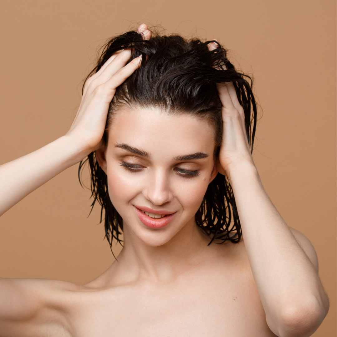 a woman touching her wet hair