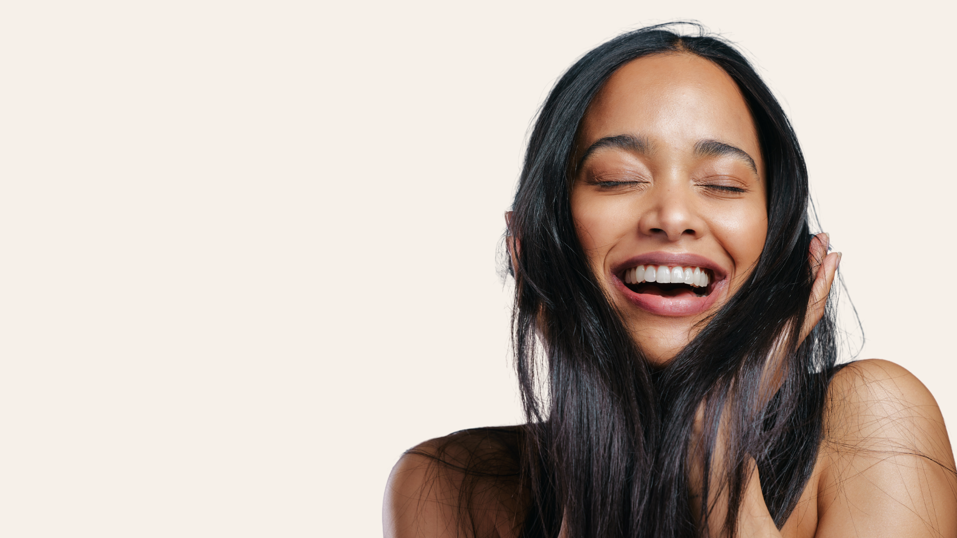 a woman holding her hair laughing