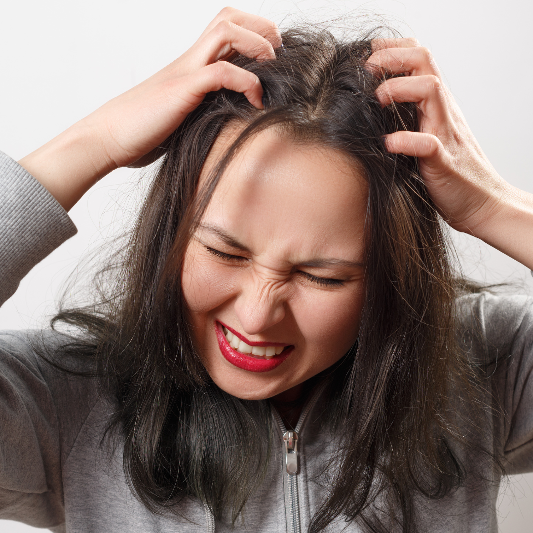a woman scratching her hair 