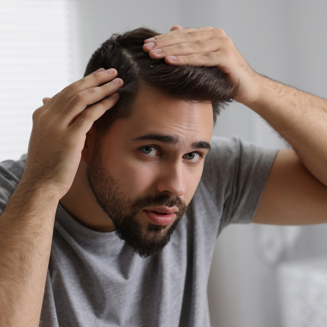 a man checking his scalp