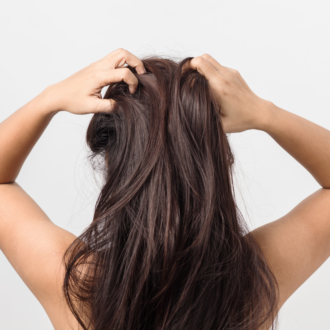a person scratching their long hair