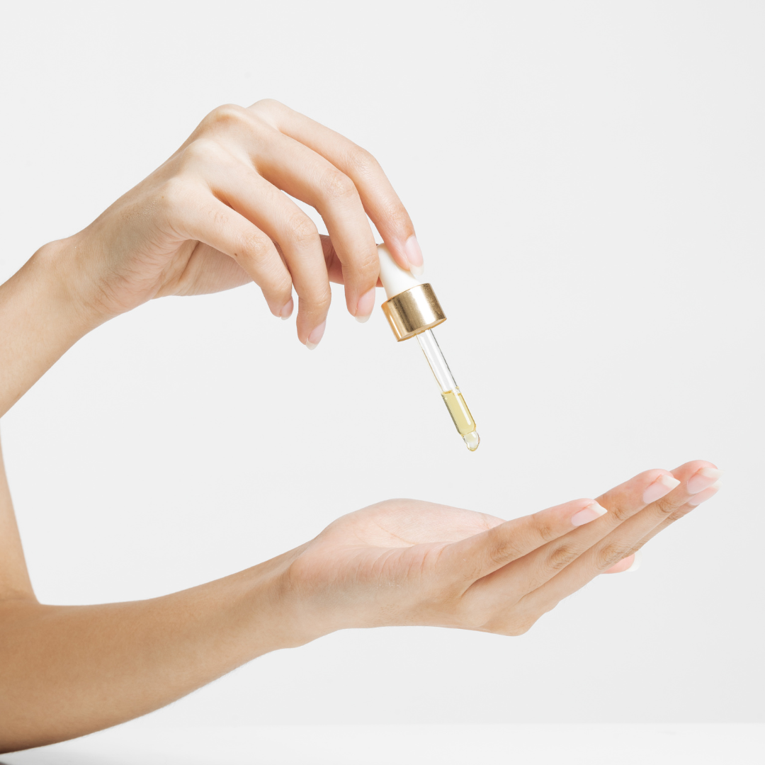 Hands Holding Cosmetic Dropper with Oil