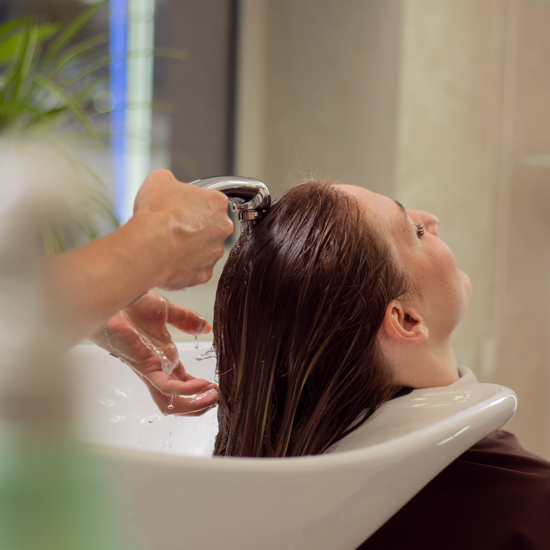 a woman getting her hair washed
