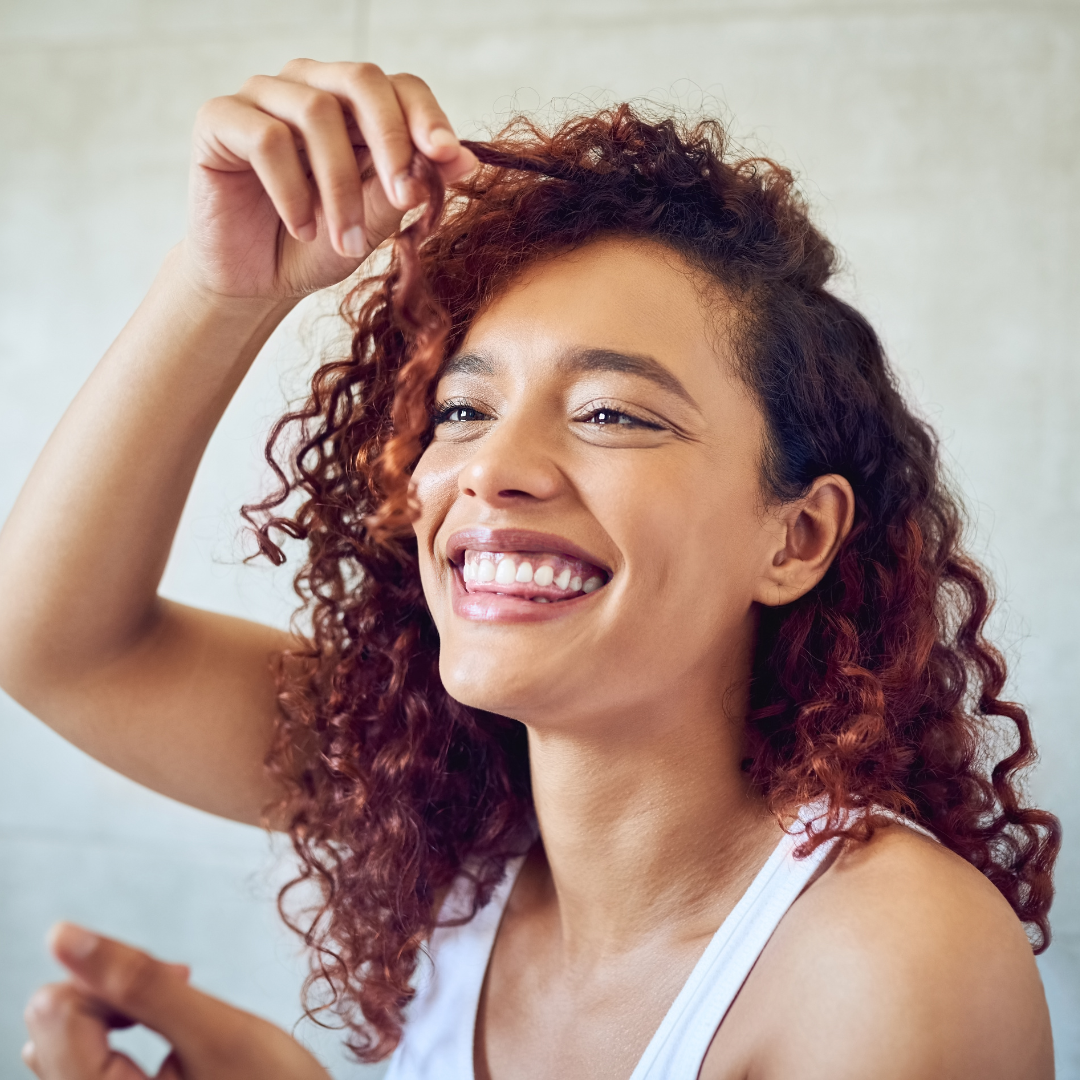 woman happily touching her hair