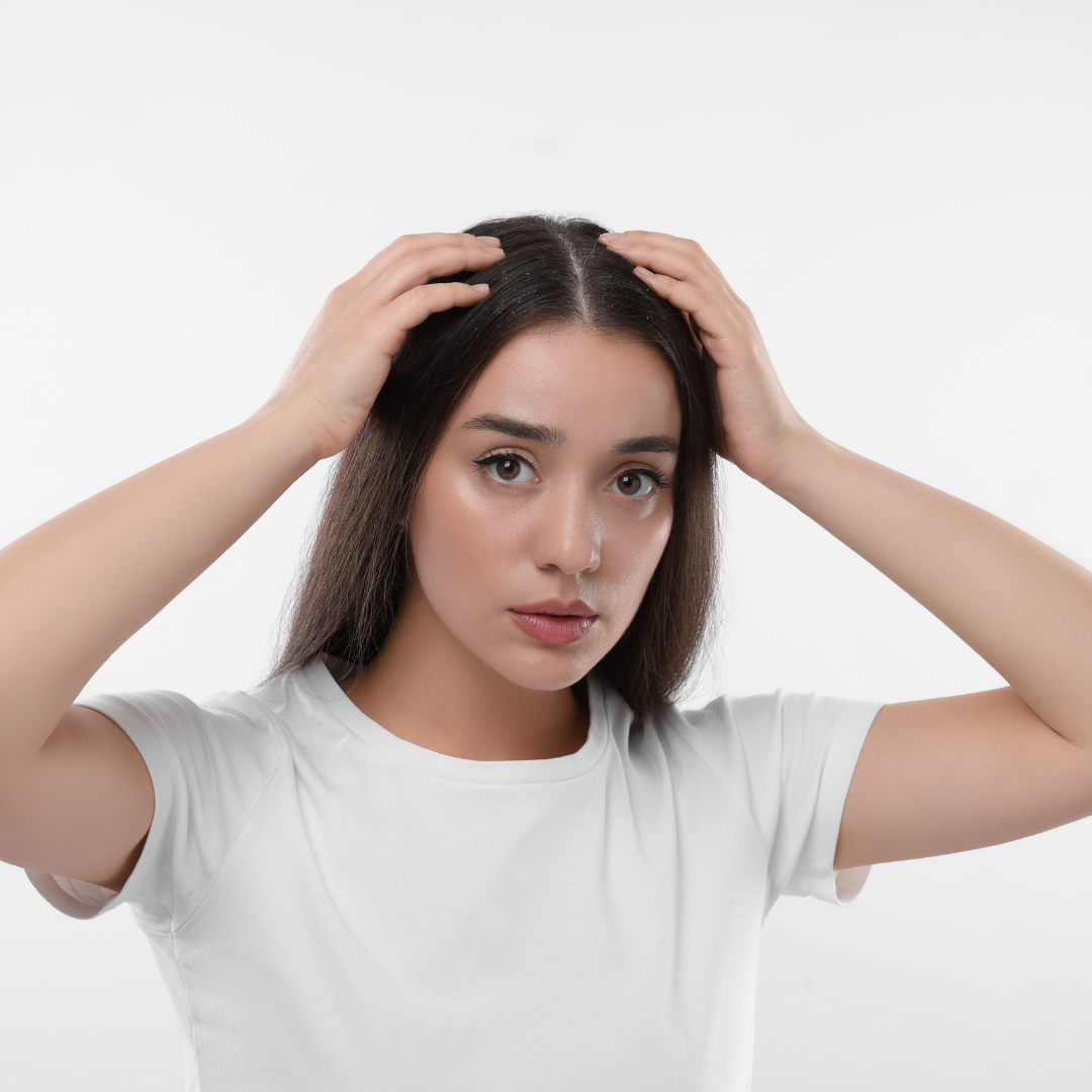 woman checking her scalp on white background