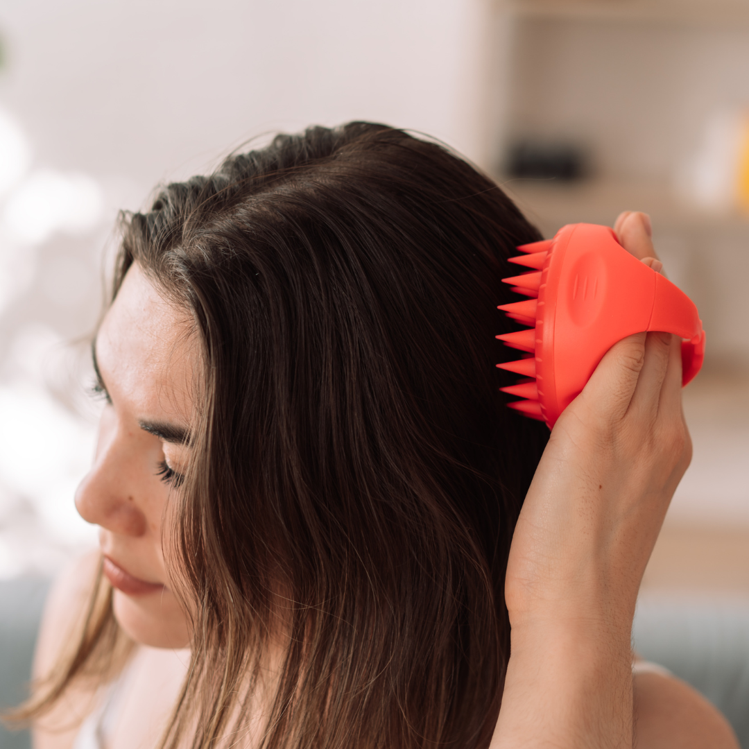 woman doing her head massage with scalp massager