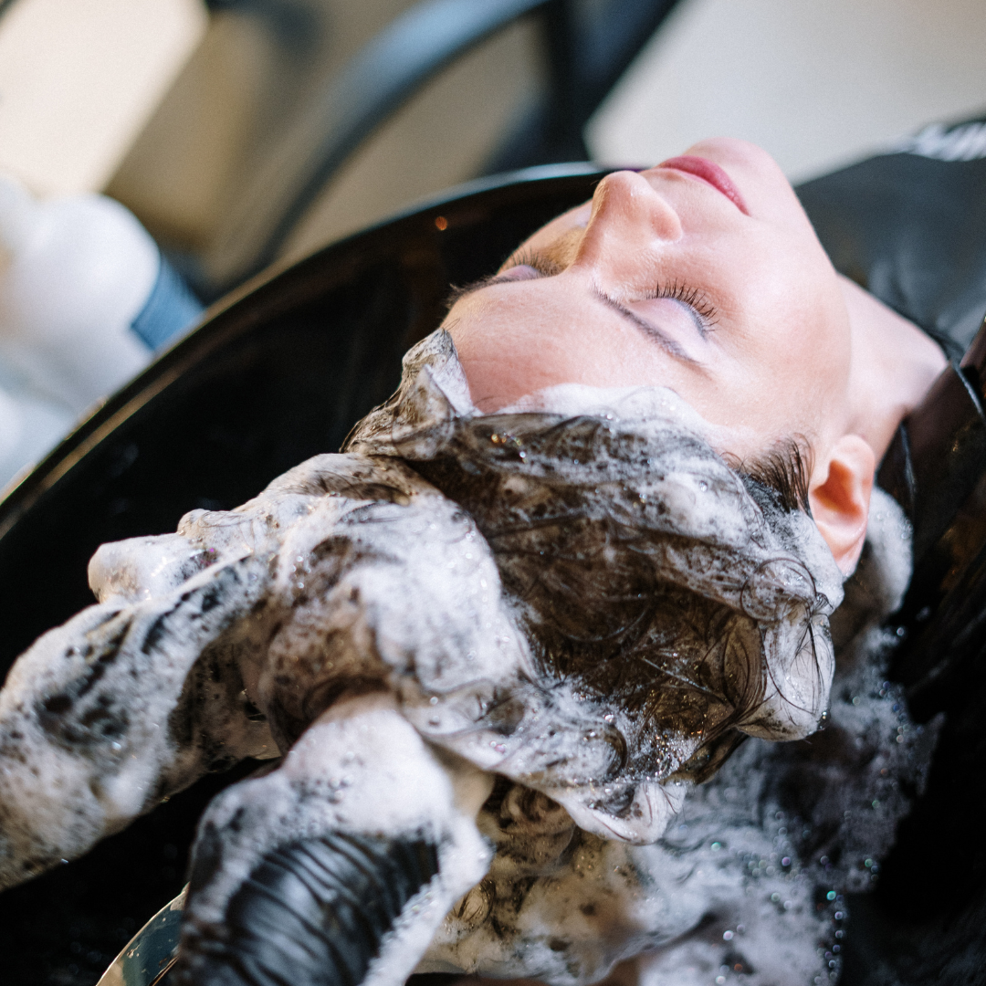 woman getting her hair shampoo