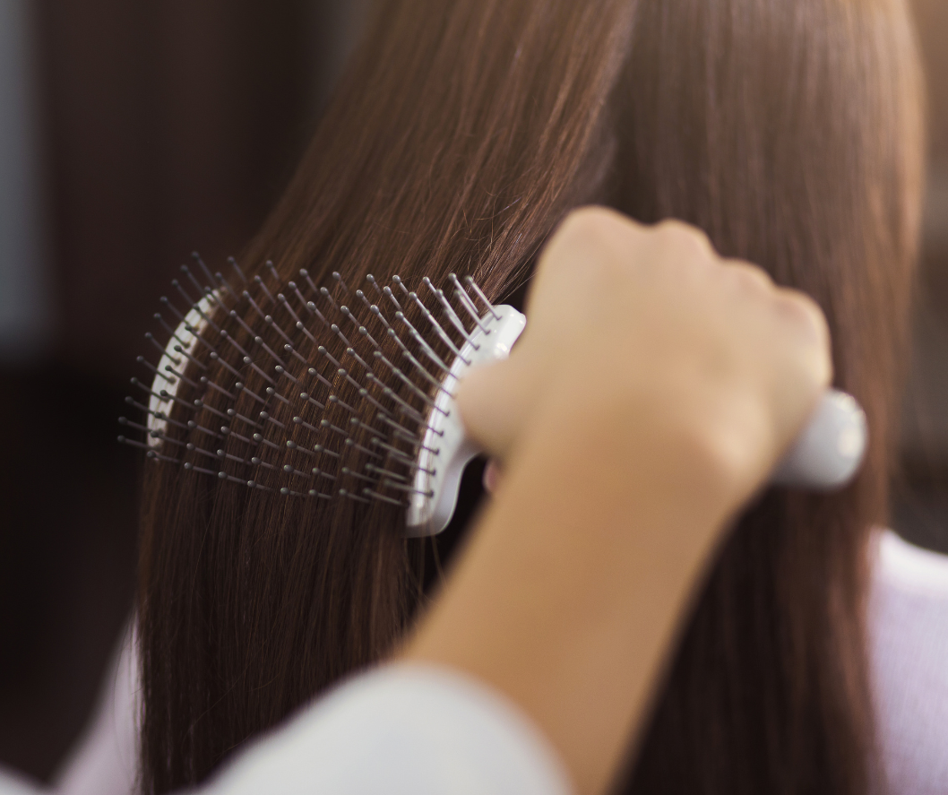 Person using a comb to style hair