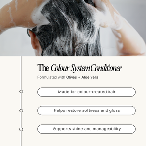 Person washing hair with a conditioner labeled 'The Colour System Conditioner' on a white background.