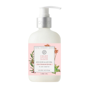 Shampoo bottle with pink label featuring green leaves on a white background