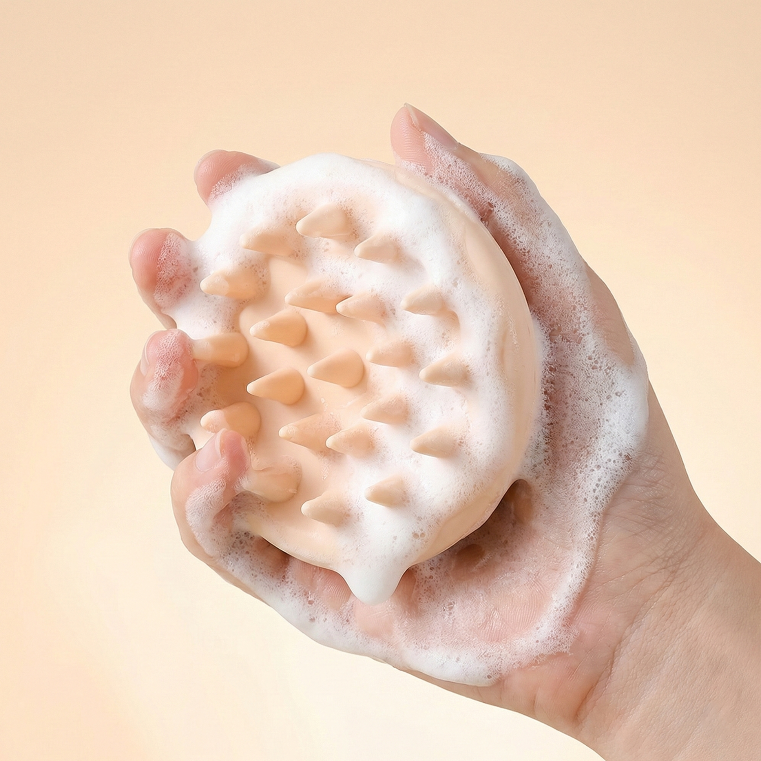 Foamy scrubber with textured surface held in a hand against a beige background