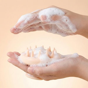 Two hands with soapy foam on a beige background