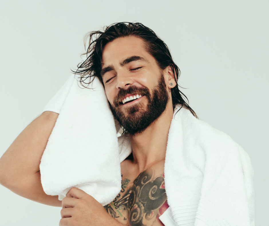 a man drying his hair with a towel