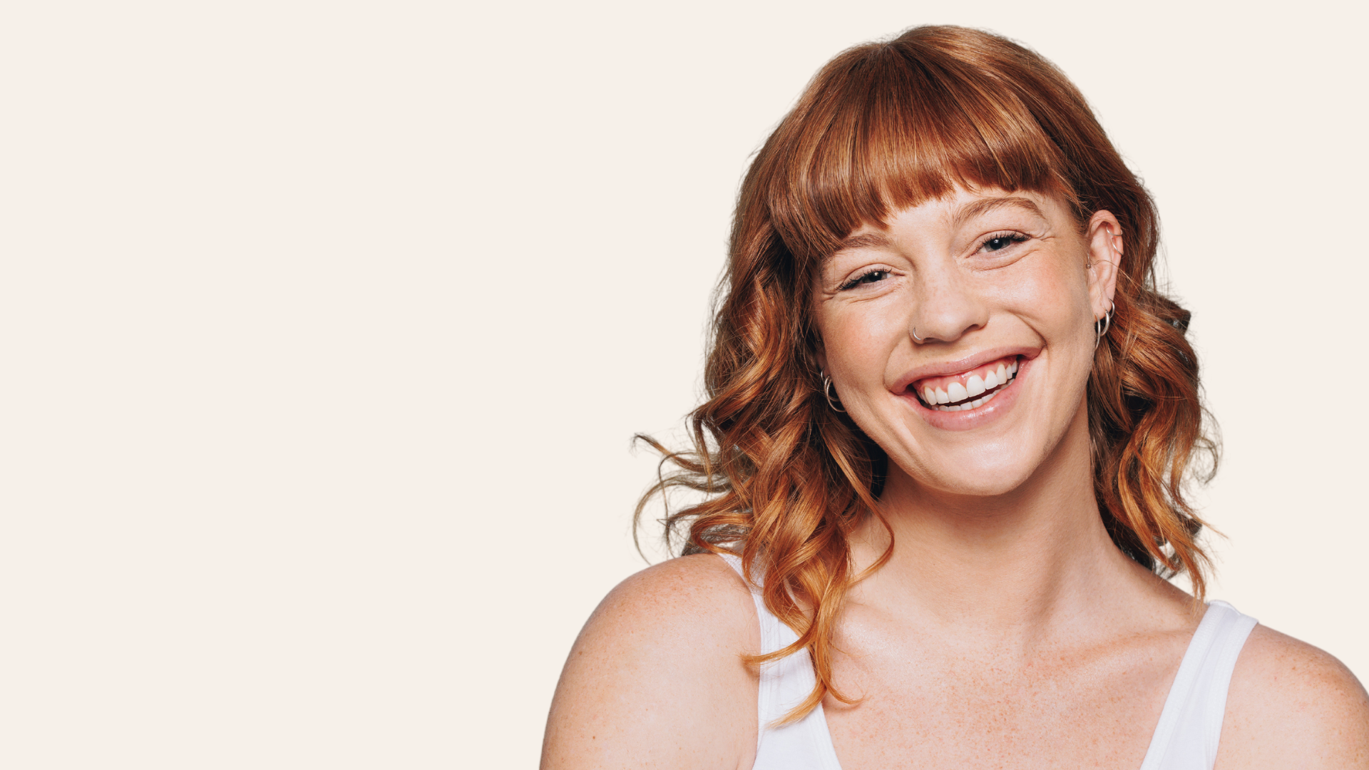 a woman with curly hair smiling