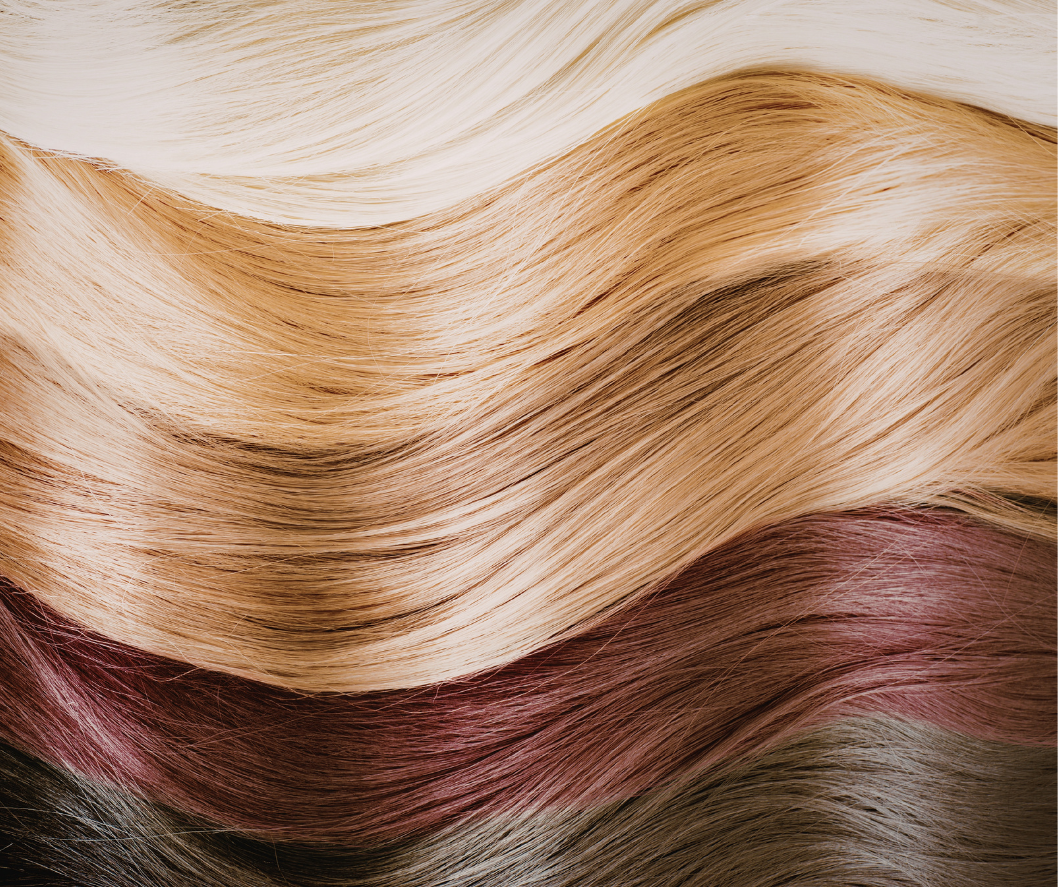 Close-up of wavy hair with blonde, brown, and red tones.