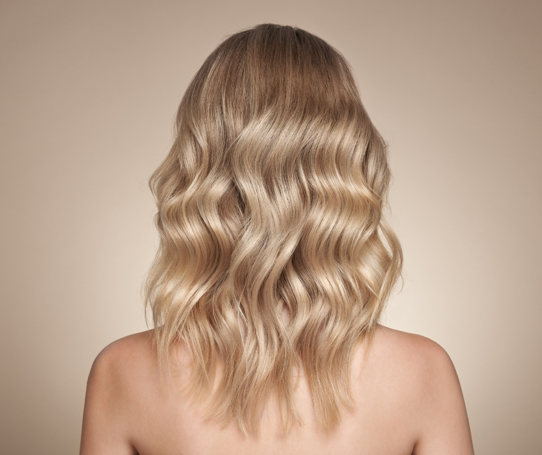 Blonde wavy hair on a beige background