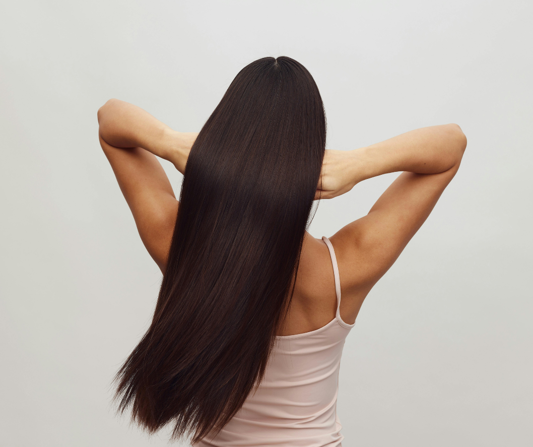 Woman with long, straight hair against a plain background